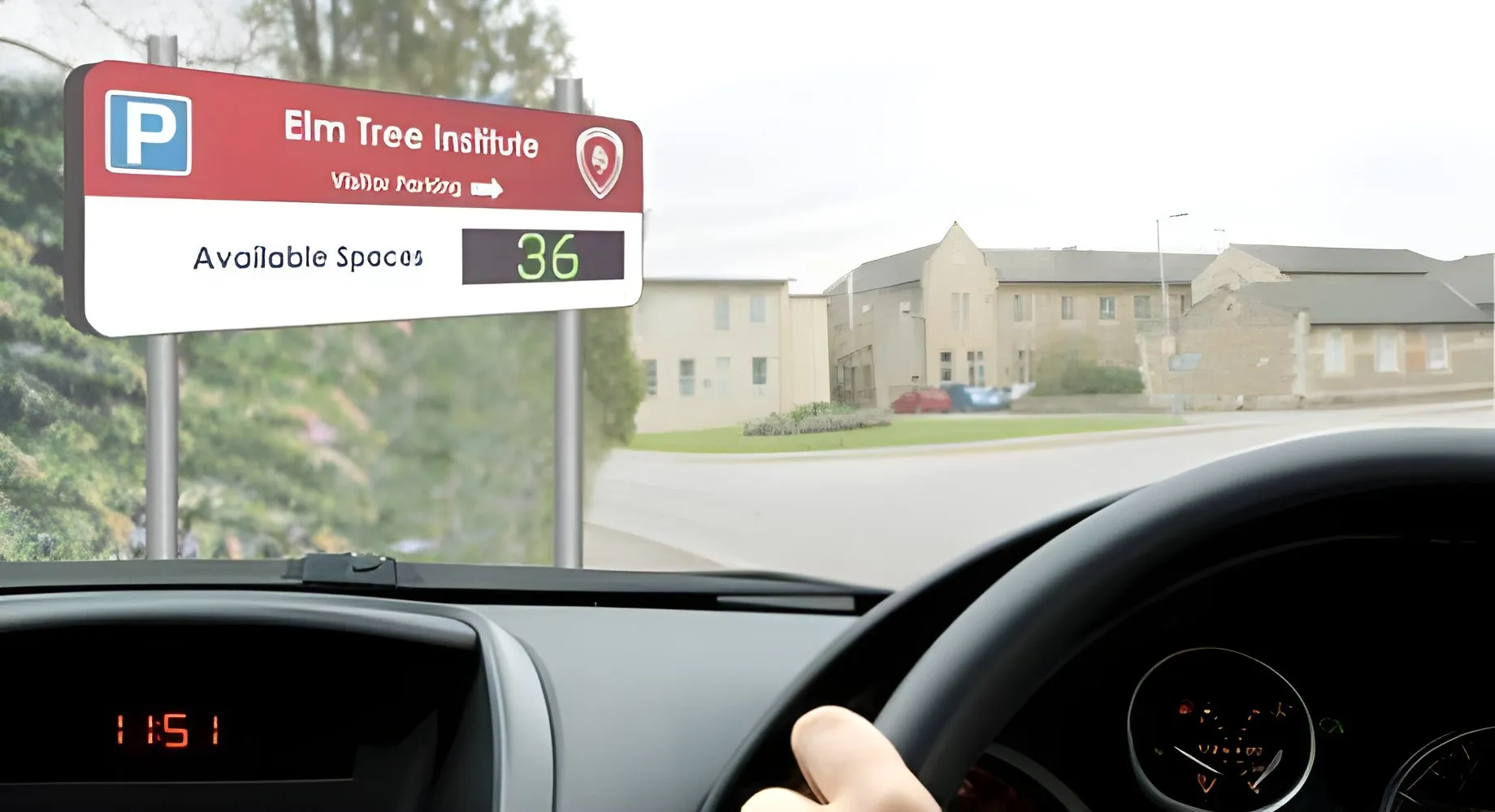 Car park entrance barrier with a camera and an electronic sign