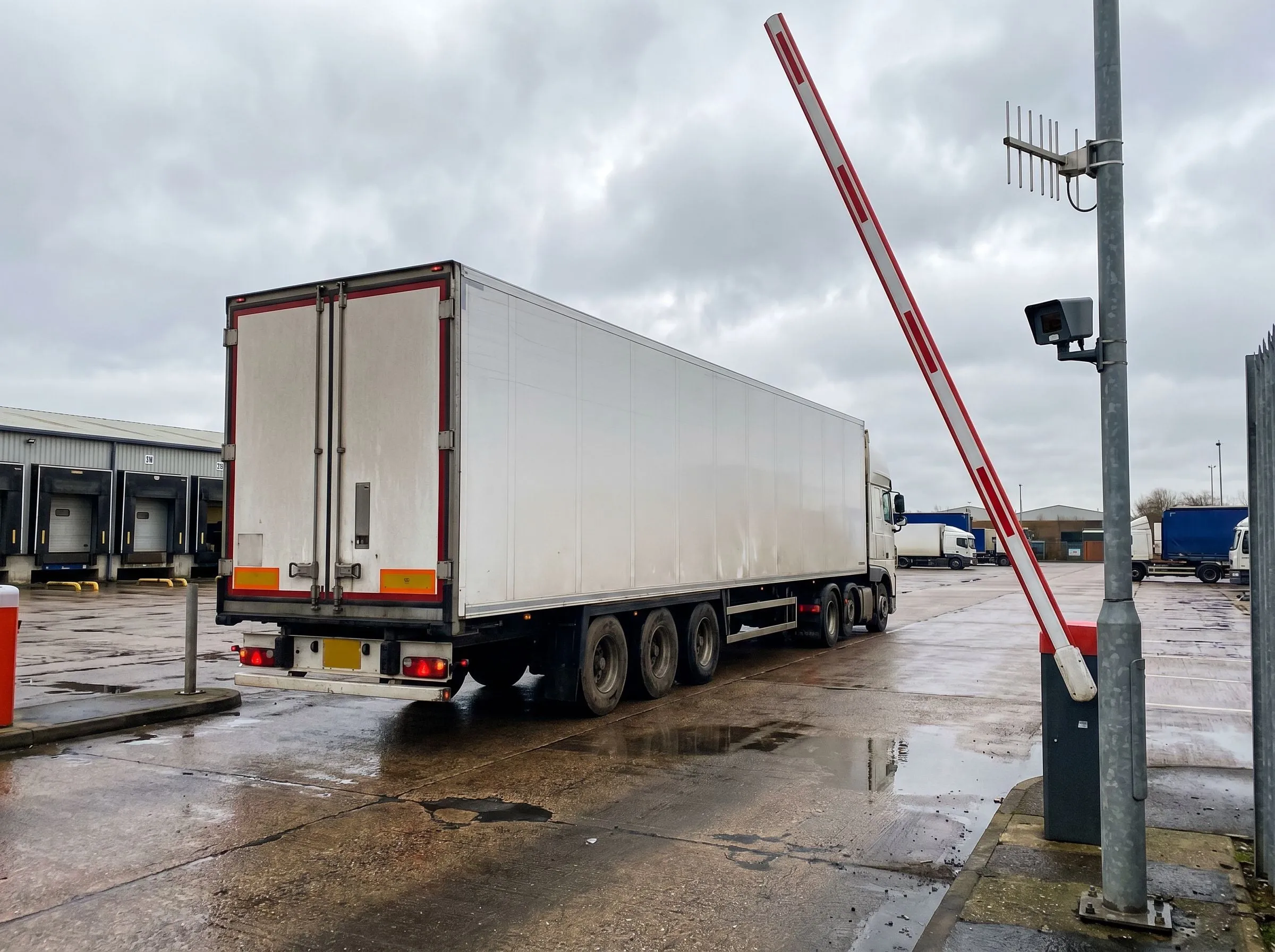 HGV passing the raised barrier at a distribution centre gate