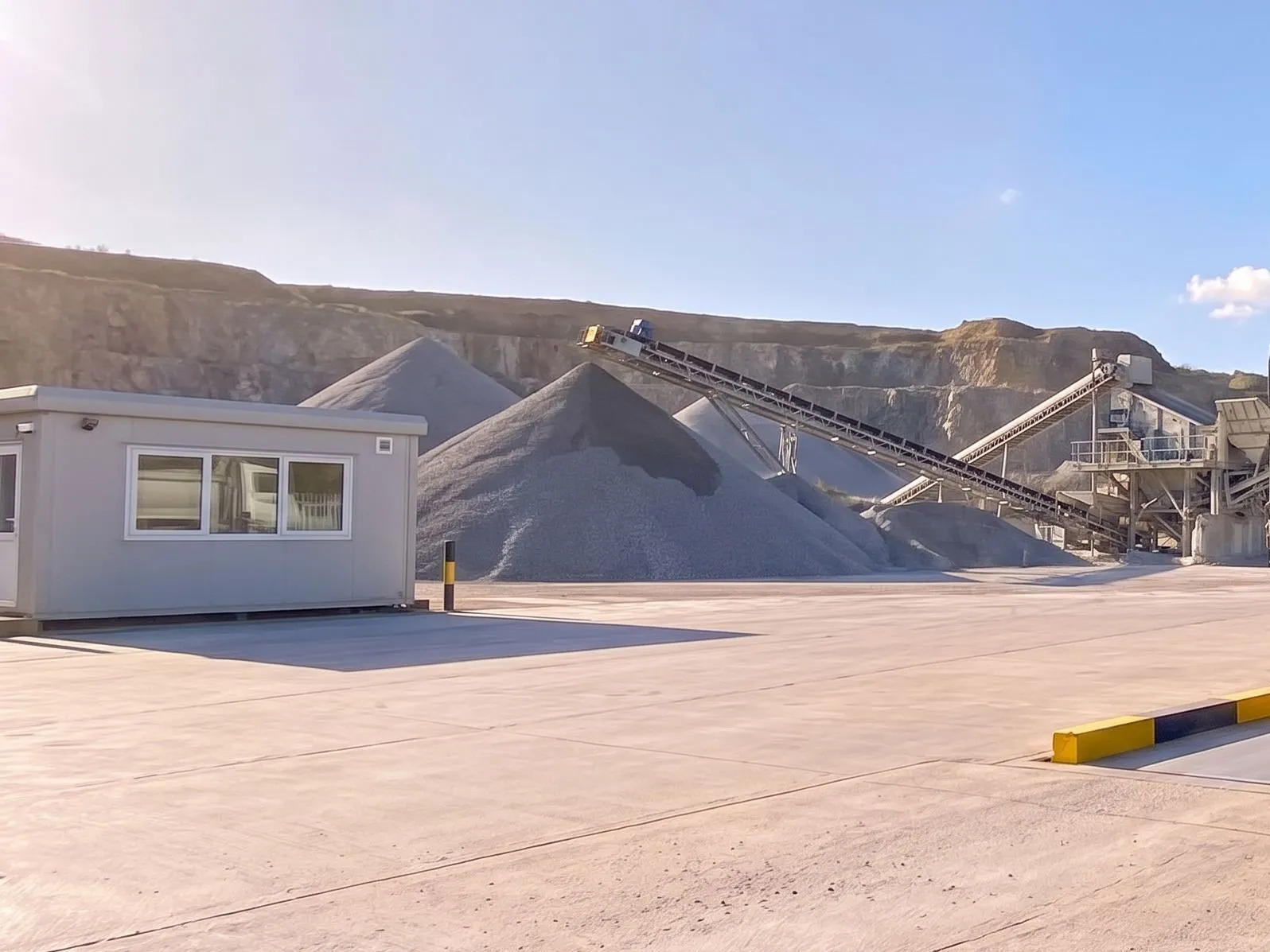 Weighbridge office, aggregate stockpiles and the conveyor at a quarry yard
